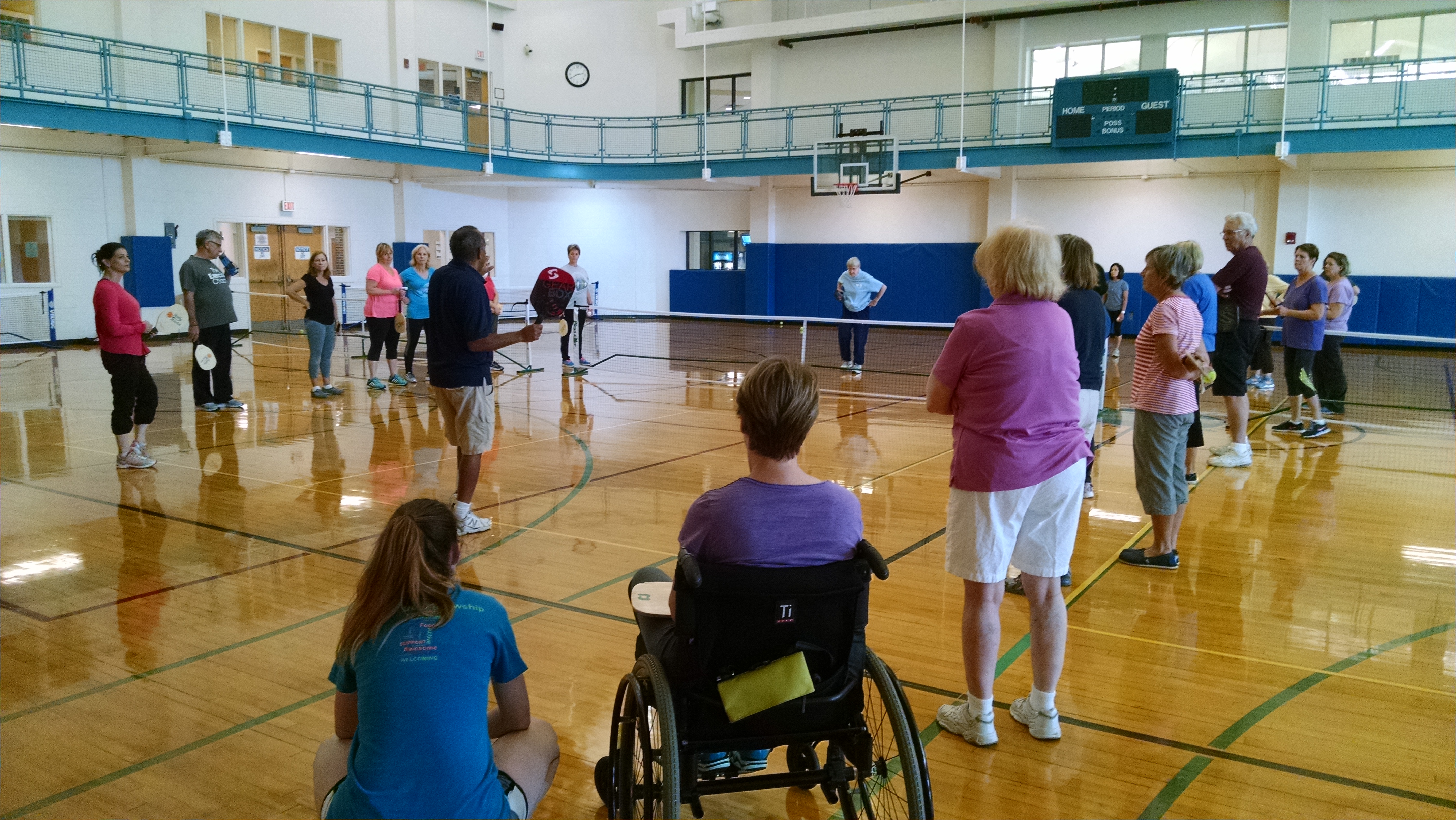 Illustration of Inclusion in recreation; pickleball class with seated and standing participants