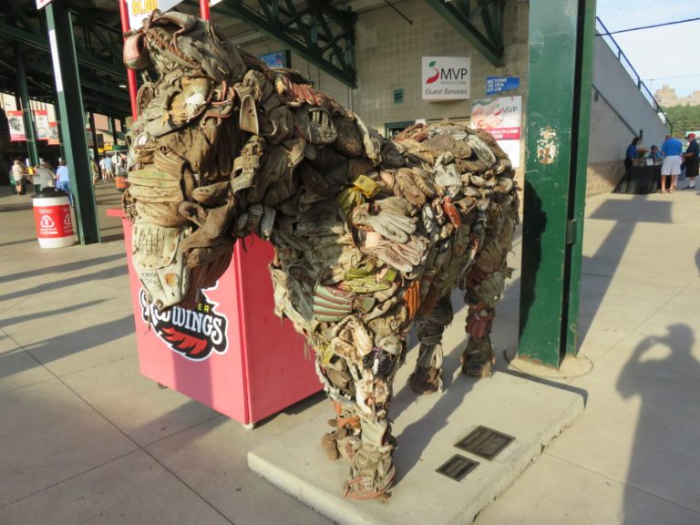 A horse built of leather baseball gloves stands in the entryway to the Redwings baseball stadium