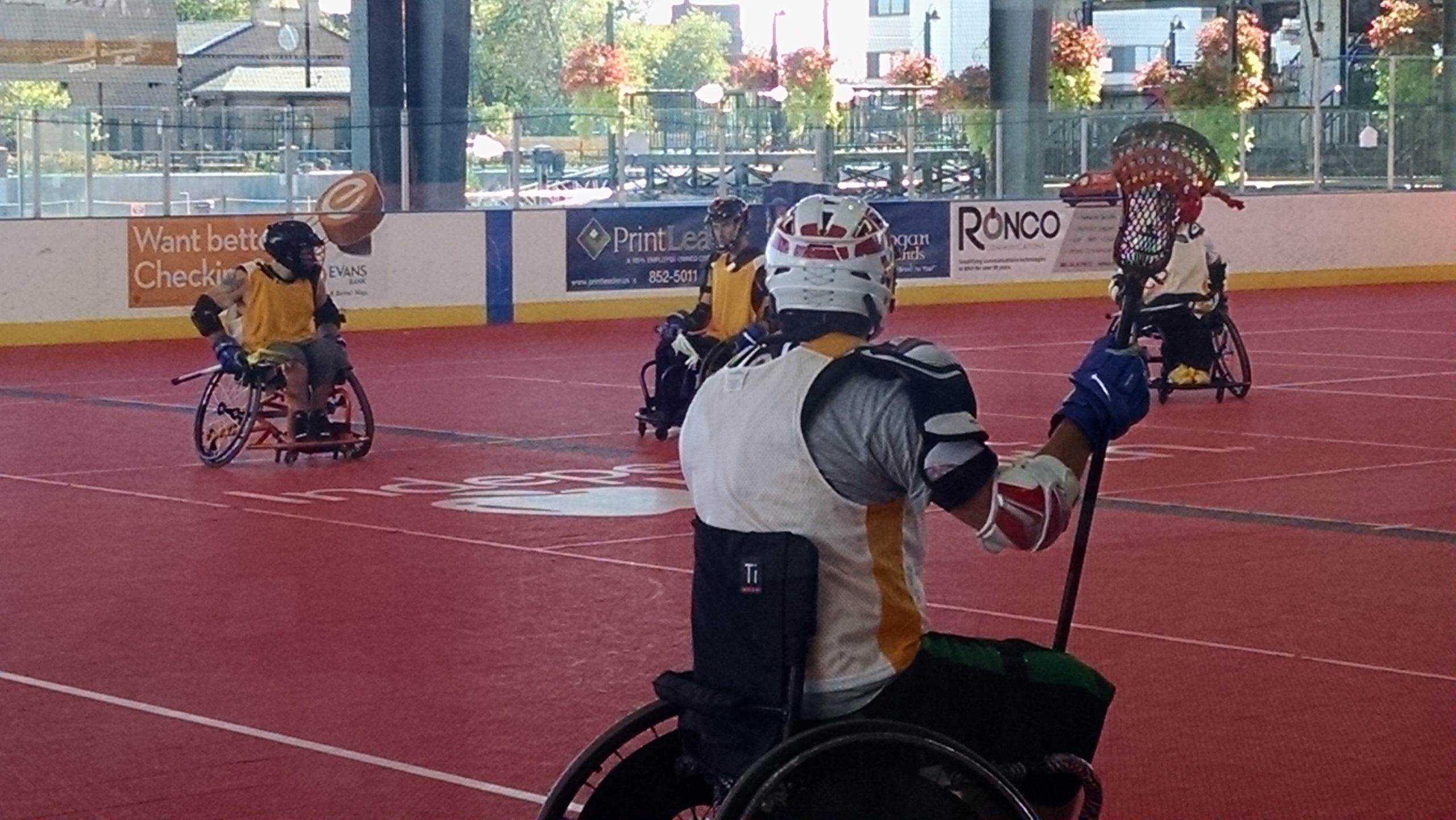 Wheelchair lacrosse athletes playing