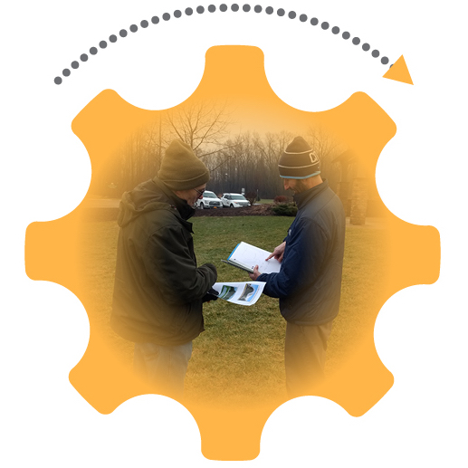 Orange gear graphic with an arrow denoting movement; photo inside the gear of two men outside comparing notes on their notebooks