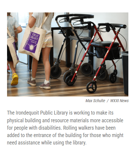 Screenshot of a assistive walkers place at the entrance of a library, several people walking by with Irondequoit Library bags