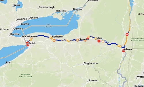 Map of NY with a blue line across from Buffalo to Albany and then north; icons show amenities along the canalway trail
