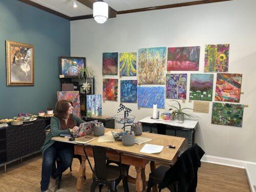 Several people mingling in an art studio