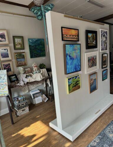 An interior of an arts studio with a moveable wall for displays and allows for more private group art sessions.