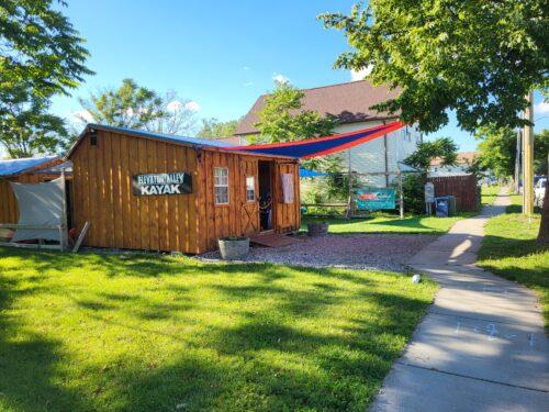 The Elevator Alley Kayak rental building stands ready to welcome visitors on a sunny day.