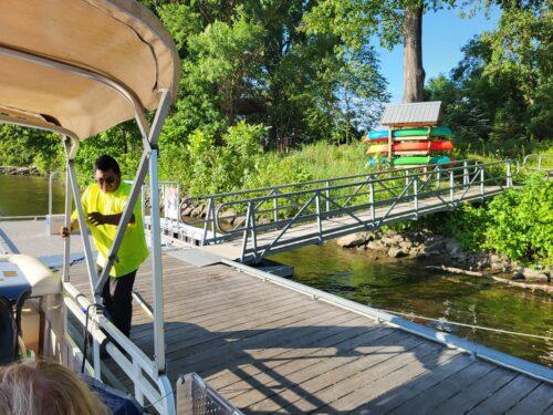 A new BoardSafe adaptive kayak launch installed at the water's edge on a wooden dock, ready for use.